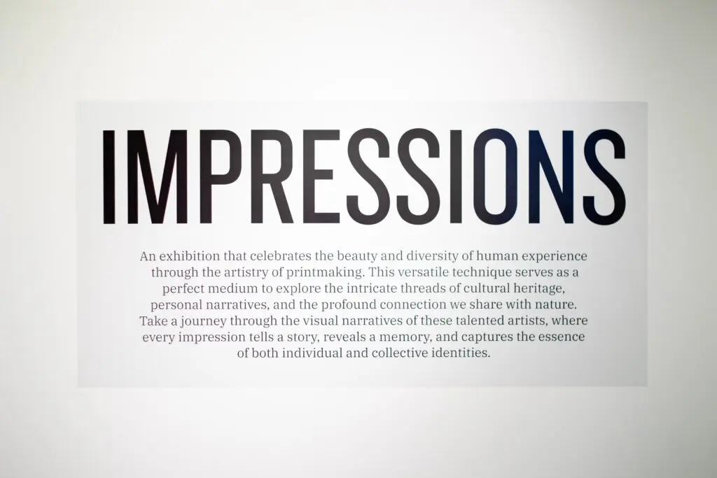Exhibit sign for "Impressions" curated local art show with description