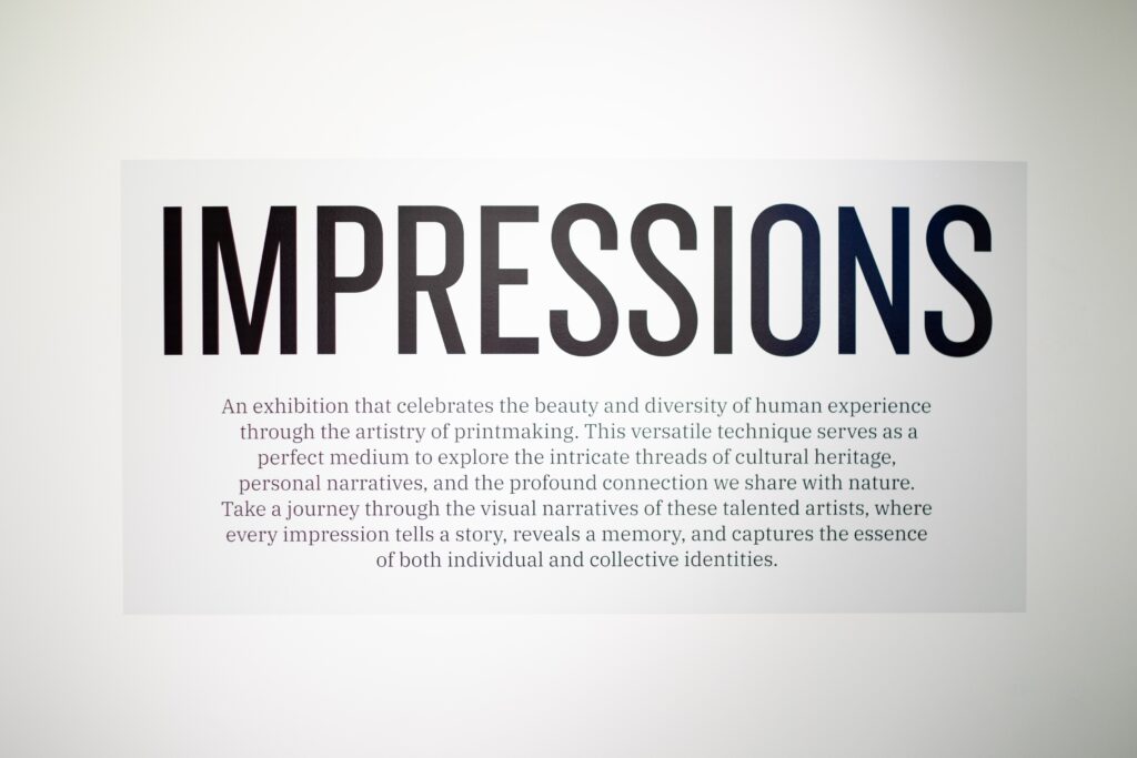 Exhibit sign for "Impressions" curated local art show with description